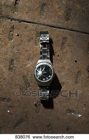 Broken wristwatch on concrete View Large Photo Image Stock Photograph - Broken wristwatch on concrete. Fotosearch