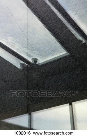 Stock Photograph - Building ceiling and skylight scene in a reflection. Fotosearch