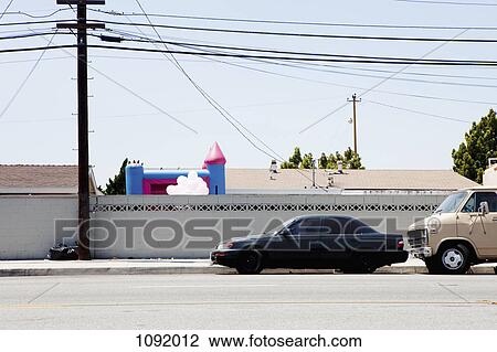 Car and Van parked next to wall with bouncy castle in background View Large Photo Image Stock Image - Car and Van parked next to wall with bouncy castle in background. Fotosearch