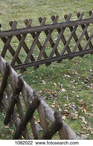 Crisscross wooden fence on grass View Large Photo Image Stock Image - Crisscross wooden fence on grass. Fotosearch