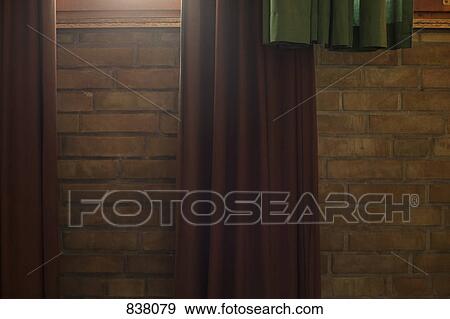 Stock Photo - Curtains hung over wall. Fotosearch