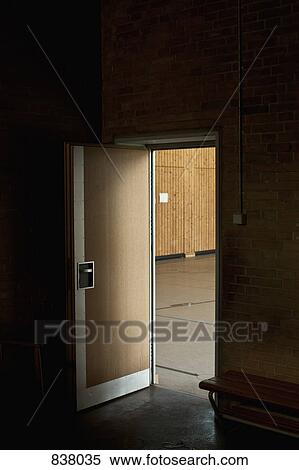 Dark room with door open revealing gym View Large Photo Image Stock Photography - Dark room with door open revealing gym. Fotosearch