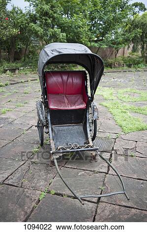 Empty Chinese rickshaw on paving stones View Large Photo Image Stock Image - Empty Chinese rickshaw on paving stones. Fotosearch