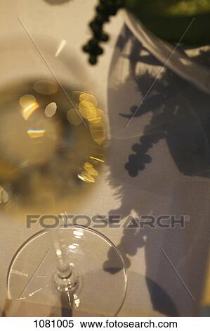 Glass of champagne on table View Large Photo Image Stock Photography - Glass of champagne on table. Fotosearch