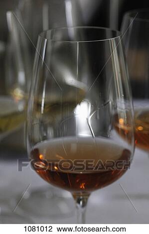Glass of white wine with tears of wine falling down the side View Large Photo Image Stock Image - Glass of white wine with tears of wine falling down the side. Fotosearch