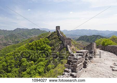 Stock Photo - Great wall of China and mountain range in background. Fotosearch