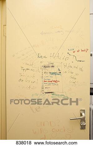 Stock Photo - Handwritten graffiti on bathroom door. Fotosearch