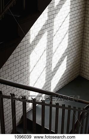 Light through window onto wall over staircase View Large Photo Image Stock Photo - Light through window onto wall over staircase. Fotosearch