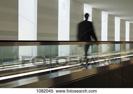 Man on travelator View Large Photo Image Stock Photography - Man on travelator. Fotosearch