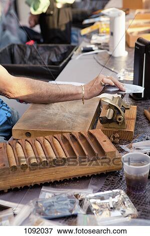 Man using tools in cigar making factory View Large Photo Image Stock Photo - Man using tools in cigar making factory. Fotosearch