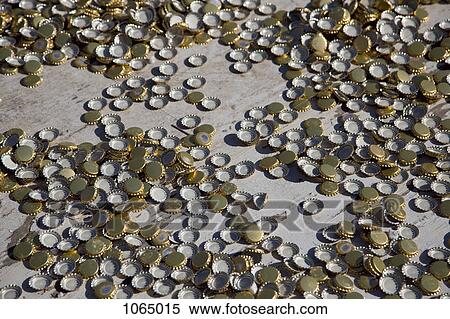 Many bottle caps strewn across a floor View Large Photo Image Stock Photography - Many bottle caps strewn across a floor. Fotosearch