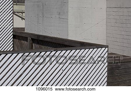 Merge of shapes of striped fence, wooden walkway and surrounding wall View Large Photo Image Stock Photography - Merge of shapes of striped fence, wooden walkway and surrounding wall. Fotosearch