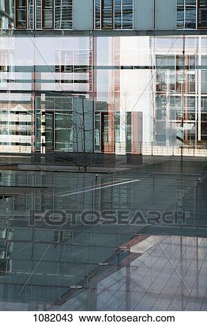 Stock Image - Mixed reflections on glass floor and walls of Jakob Kaiser Haus. Fotosearch