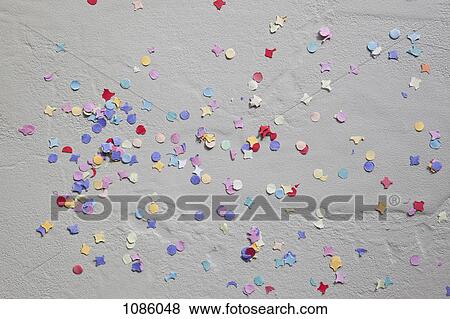 Multi colored confetti on a gray background View Large Photo Image Stock Photo - Multi colored confetti on a gray background. Fotosearch
