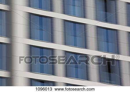 Stock Image - Out of focus abstract view of office building facade. Fotosearch