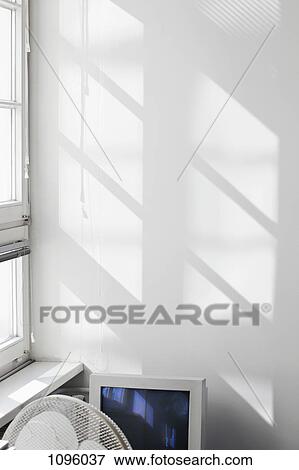 Outline of window shadowed on wall behind fan and monitor View Large Photo Image Stock Photo - Outline of window shadowed on wall behind fan and monitor. Fotosearch
