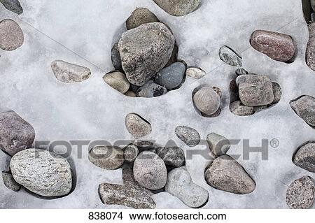 Patterns formed by ice over pebbles View Large Photo Image Picture - Patterns formed by ice over pebbles. Fotosearch