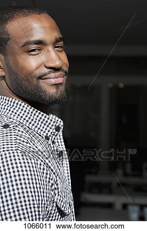 Stock Image - Portrait of a man smiling. Fotosearch