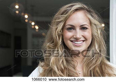 Stock Image - Portrait of a young woman smiling. Fotosearch