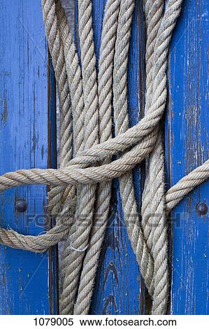Rope in between blue painted wood, close-up View Large Photo Image Stock Photography - Rope in between blue painted wood, close-up. Fotosearch