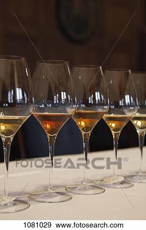 Row of wine glasses on table ready for wine tasting View Large Photo Image Stock Photo - Row of wine glasses on table ready for wine tasting. Fotosearch