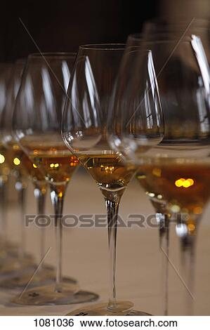 Row of wine glasses on table View Large Photo Image Stock Photograph - Row of wine glasses on table. Fotosearch