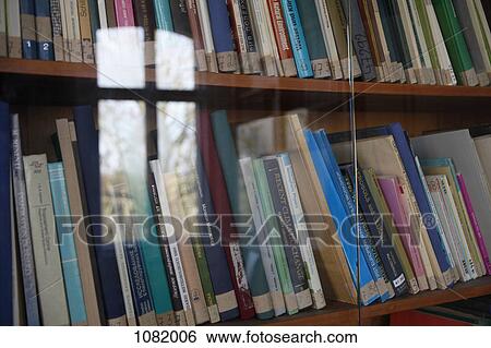 Rows of books behind glass doors View Large Photo Image Stock Photograph - Rows of books behind glass doors. Fotosearch