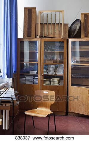 School music room showing instruments, music books and an empty chair View Large Photo Image Stock Photo - School music room showing instruments, music books and an empty chair. Fotosearch