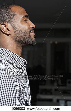 Side view of a man with his eyes closed and smiling View Large Photo Image Stock Image - Side view of a man with his eyes closed and smiling. Fotosearch