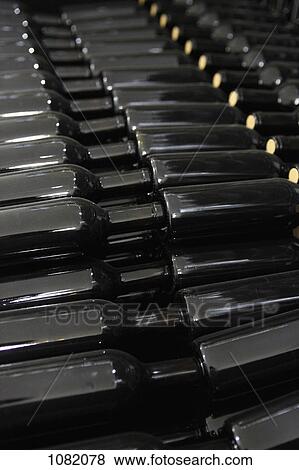 Stock Photo - Stack of red wine bottles. Fotosearch