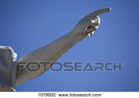 Statue pointing, blue sky background, close-up of arm View Large Photo Image Stock Image - Statue pointing, blue sky background, close-up of arm. Fotosearch
