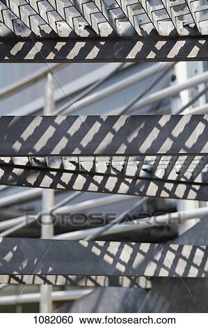 Stock Image - Steps from a metal staircase, close-up. Fotosearch