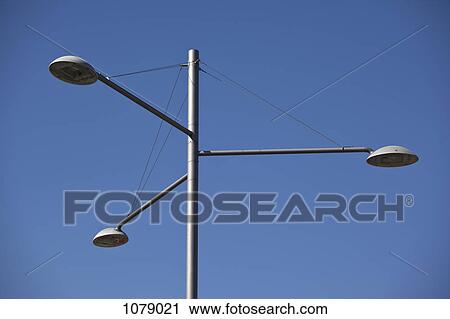 Street lights against a clear blue sky View Large Photo Image Stock Image - Street lights against a clear blue sky. Fotosearch