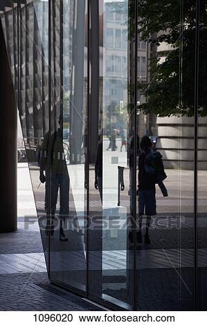Three curious people by glass facade View Large Photo Image Stock Image - Three curious people by glass facade. Fotosearch