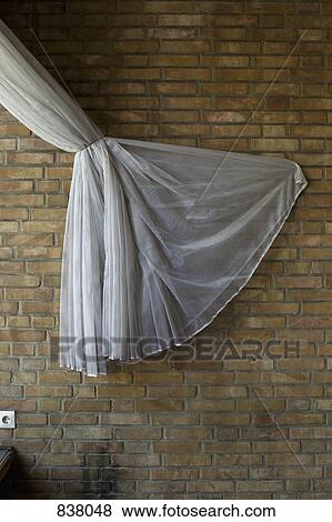 Tied curtain on a wall background View Large Photo Image Stock Photo - Tied curtain on a wall background. Fotosearch