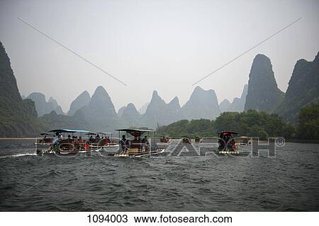 Tour boats sailing on the River Li in China View Large Photo Image Stock Image - Tour boats sailing on the River Li in China. Fotosearch