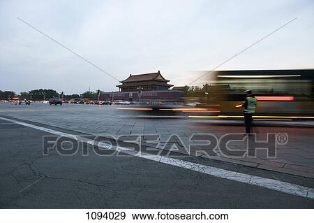 Traffic warden beside moving traffic in Tiananmen Square, Beijing View Large Photo Image Stock Photo - Traffic warden beside moving traffic in Tiananmen Square, Beijing. Fotosearch