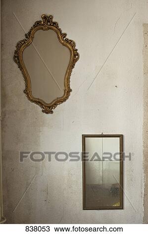 Two old mirrors hanging on bare wall View Large Photo Image Stock Image - Two old mirrors hanging on bare wall. Fotosearch