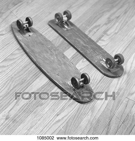 Stock Image - Two old wooden skateboards side by side. Fotosearch