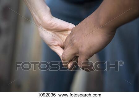 Two people holding hands View Large Photo Image Stock Photograph - Two people holding hands. Fotosearch