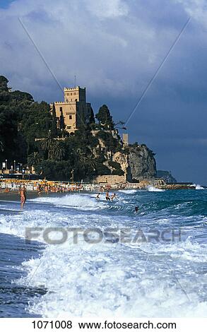 Stock Photo - View of a beach and a castle in the background, Liguria, Italy. Fotosearch