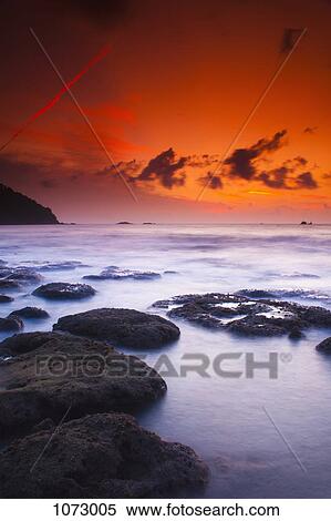 View of the sea at sunset View Large Photo Image Stock Photography - View of the sea at sunset. Fotosearch