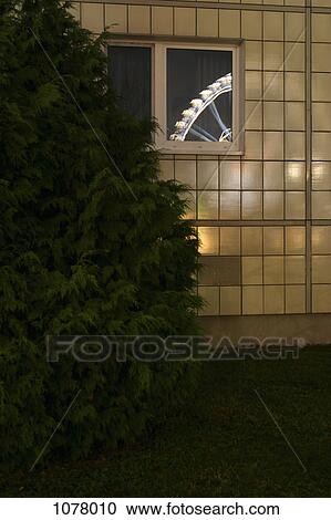 Stock Image - View through a window of a ferris wheel. Fotosearch