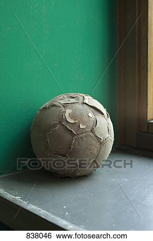 Worn out soccer ball on ledge View Large Photo Image Stock Photograph - Worn out soccer ball on ledge . Fotosearch