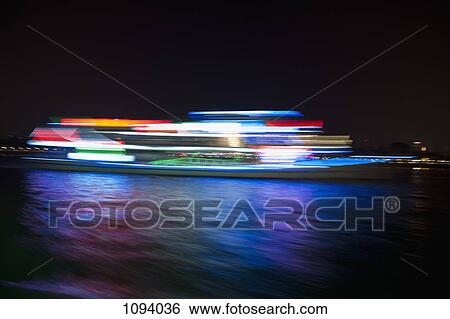 Stock Photograph - Yacht on water in Hong Kong harbor. Fotosearch