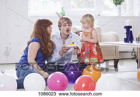 Young family celebrating a birthday View Large Photo Image Stock Image - Young family celebrating a birthday. Fotosearch