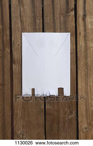 Stock Photograph - A blank flyer hanging on a wooden fence. Fotosearch