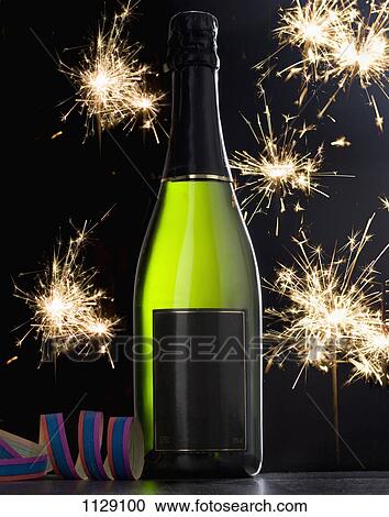 Stock Image - A bottle of champagne and sparklers. Fotosearch