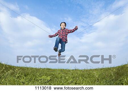 A boy jumping in the air View Large Photo Image Stock Photo - A boy jumping in the air. Fotosearch