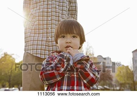 A boy standing in front of his father View Large Photo Image Stock Photograph - A boy standing in front of his father. Fotosearch
